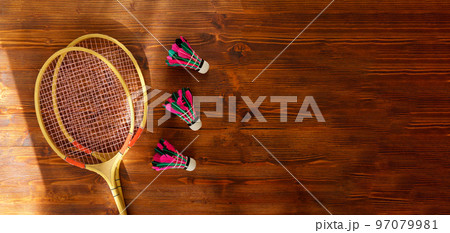 Shuttlecocks and badminton rackets on wooden background. Flat lay. Copy space Shuttlecocks and badminton rackets on wooden background. Flat lay. Copy space 97079981