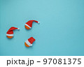 Christmas, New Year blue stylish flat frame with tangerines in santa hats. Winter holiday composition. View from above. 97081375