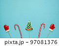 Christmas or winter composition. Frame made of snowflakes and candy trees on a red background. Christmas, winter, new year concept. Flat lay 97081376