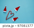 Christmas, New Year blue stylish flat frame with lollipops and santa claus hat. Winter holiday composition. 97081377