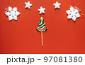 Christmas or winter composition. Frame made of snowflakes and candy trees on a red background. Christmas, winter, new year concept. Flat lay 97081380