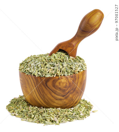 Fennel seeds in wooden bowl and spoon, isolated on white background. Green fennel grains. Spices and herbs. 97081527