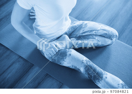 fitness, sport, training and lifestyle concept - woman stretching on mat in gym 97084821