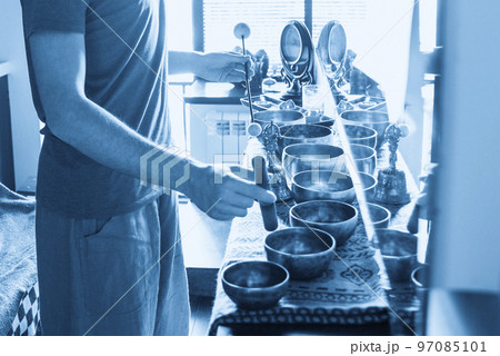 Tibetan singing bowls in sound therapy in spa center 97085101