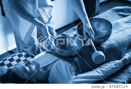 Tibetan singing bowls in sound therapy in spa center 97085124