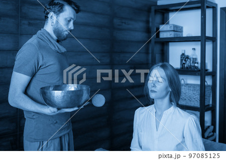 Tibetan singing bowls in sound therapy in spa center 97085125