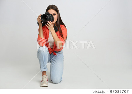 Professional photographer working on white background in studio 97085707