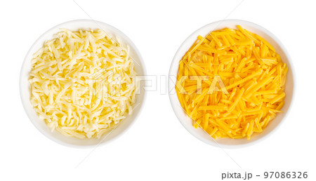 Shredded mozzarella and cheddar cheese, in white bowls. Grated low-moisture mozzarella, and piquant, orange colored natural cheese, both made of pasteurized cow milk. Used for pizza and pasta dishes. 97086326