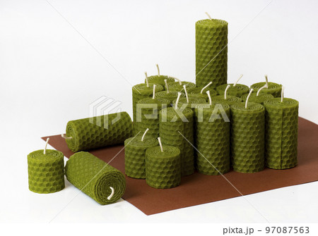 a group of green beeswax candles a group of green beeswax candles 97087563
