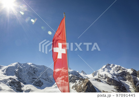 Swiss flag and Bernina mountain range with glaciers in the Alps, Switzerland Swiss flag and Bernina mountain range with glaciers in the Alps, Switzerland 97091445
