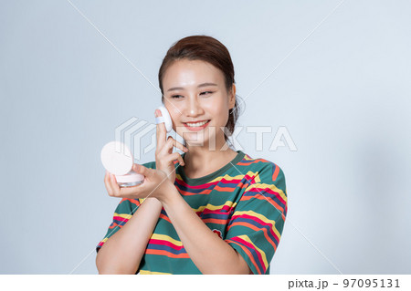 beautiful young woman using beauty blender for applying foundation for make-up on face isolated beautiful young woman using beauty blender for applying foundation for make-up on face isolated 97095131
