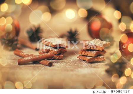 Christmas table. blurred image homemade cookies on wooden background. beautiful bokeh effect from a garland. 97099417