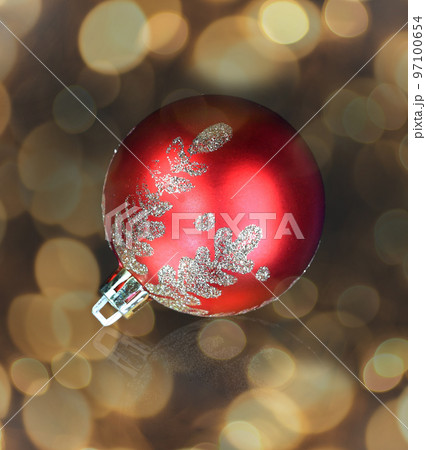 red christmas ball over dark background. photo with a copy of the space. beautiful bokeh effect from a garland. 97100654