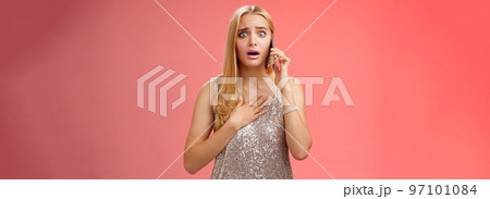 Concerned worried woman blond hairstyle in silver stylish glittering dress hold hand heart widen eyes afraid gasping speechless listen terrifying news talking smartphone express empathy worry Concerned worried woman blond hairstyle in silver stylish glittering dress hold hand heart widen eyes afraid gasping speechless listen terrifying news talking smartphone express empathy worry 97101084