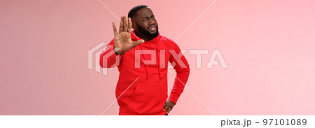Hold on, stop right there. Portrait confused perplexed african american man cringing questioned raise hand enough shut up gesture arguing hear stupid nonsense, standing pink background Hold on, stop right there. Portrait confused perplexed african american man cringing questioned raise hand enough shut up gesture arguing hear stupid nonsense, standing pink background 97101089