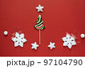 Christmas or winter composition. Frame made of snowflakes and candy trees on a red background. Christmas, winter, new year concept. Flat lay 97104790
