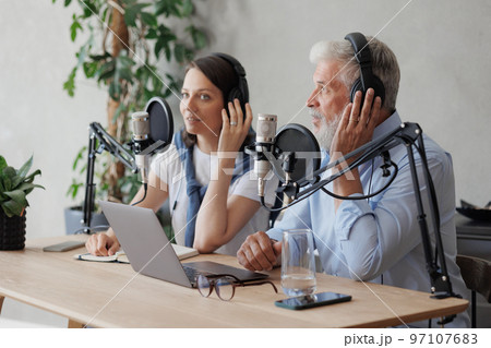 female and male podcasters record audio content in sound studio. social media, news program on radio female and male podcasters record audio content in sound studio. social media, news program on radio 97107683