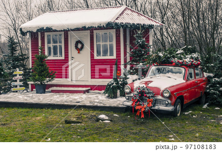 Decorated Santa's house with a red vintage car in Decorated Santa's house with a red vintage car in 97108183