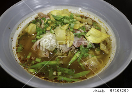 Yellow egg noodles in spicy pork soup 97108299