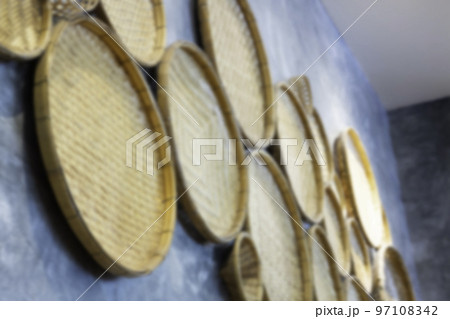 Vintage woven products hanging on rustic wall 97108342