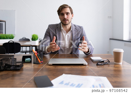 Caucasian attractive man in business clothes at an interview talks about his work experience 97108542