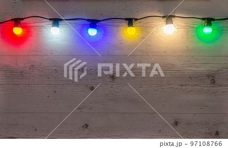 Color lamps garland on the pale wooden background Color lamps garland on the pale wooden background 97108766