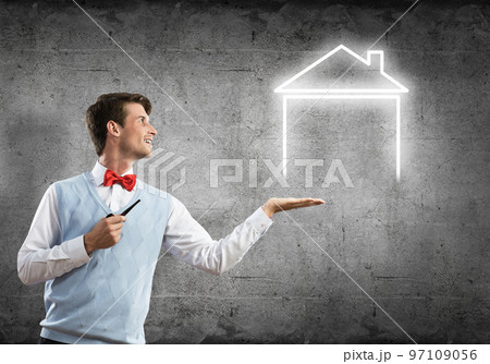 Elegant banker wearing red tie and house sign as banking concept Elegant banker wearing red tie and house sign as banking concept 97109056