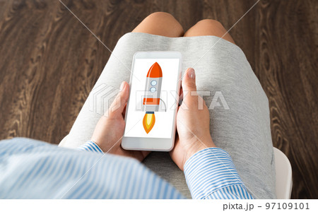 Businesswoman with a smartphone and her startup Businesswoman with a smartphone and her startup 97109101