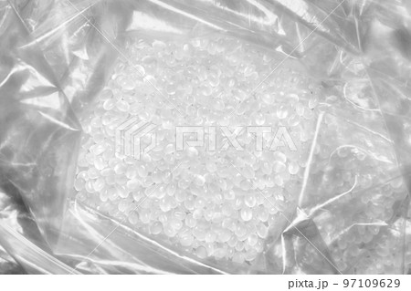 Close up picture of polypropylene granules in a plastic bag, selective focus. Close up picture of polypropylene granules in a plastic bag, selective focus. 97109629