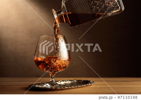 Brandy is poured into a snifter glass. 97110198