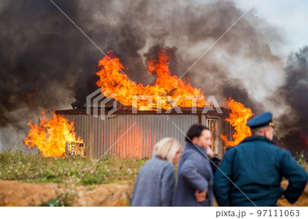 A building in fire. Training fire service to extinguish a fire, civil defense exercises A building in fire. Training fire service to extinguish a fire, civil defense exercises 97111063