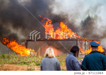 A building in fire. Training fire service to extinguish a fire, civil defense exercises A building in fire. Training fire service to extinguish a fire, civil defense exercises 97111064