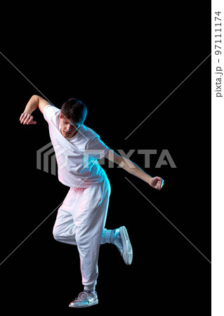 young man in black t-shirt and jeans dancing 97111174