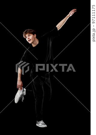 young man in black t-shirt and jeans dancing 97111175