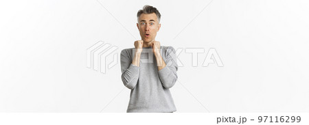 Image of scared middle-aged man with gray hair, jumping frightened and looking alarmed at something scary, standing over white background Image of scared middle-aged man with gray hair, jumping frightened and looking alarmed at something scary, standing over white background 97116299