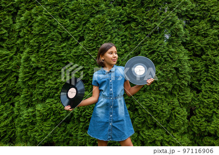 child girl holds vinyl records 97116906