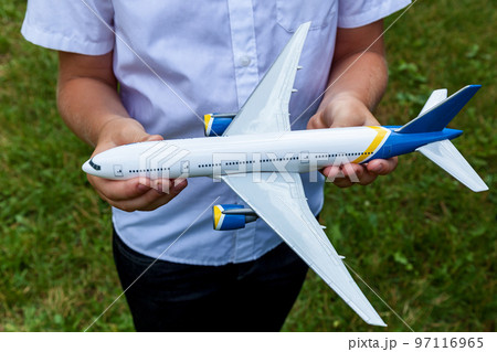 Boy holding a toy plane Boy holding a toy plane 97116965