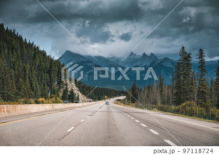 Scenic road on highway and moody sky in Canadian Rockies at Banff national park Scenic road on highway and moody sky in Canadian Rockies at Banff national park 97118724