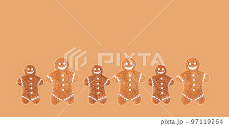 Group of christmas gingerbread men on brown background 97119264