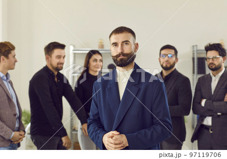 Business colleagues standing together with businessman leader on foreground 97119706