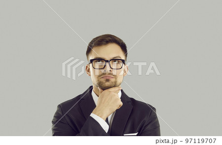 Serious businessman with doubtful uncertain facial expression hesitates to make important decision. 97119707