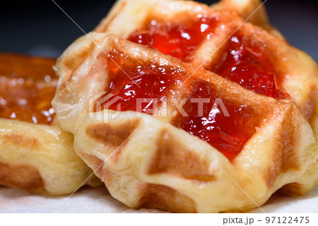 Close up fresh waffles with above strawberry jam Close up fresh waffles with above strawberry jam 97122475