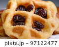 Close up fresh waffles with above dried raisins 97122477