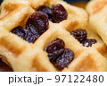 Close up fresh waffles with above dried raisins 97122480