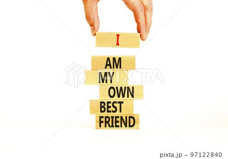 I am my own best friend symbol. Concept words I am my own best friend on wooden blocks on a beautiful white table white background. Businessman hand. Business i am my own best friend concept. 97122840