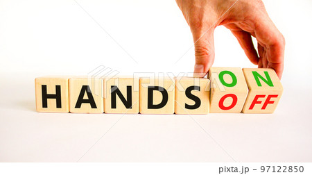 Hands on or off symbol. Concept words Hands on Hands off on wooden cubes. Businessman hand. Beautiful white table white background. Business hands on or off concept. Copy space. 97122850