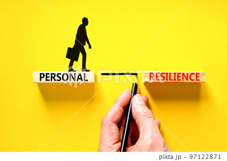 Personal resilience symbol. Concept word Personal resilience on wooden block. Beautiful yellow table yellow background. Businessman hand. Business psychological personal resilience concept. Copy space 97122871