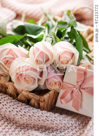 Tray with bouquet of beautiful pink roses and gift box on bed. Tray with bouquet of beautiful pink roses and gift box on bed. 97123772
