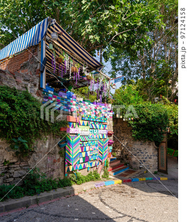 Daytime of cafe decorated with multicolored panels colorful stairs, and canopy in Balat District, Istanbul, Turkey 97124158