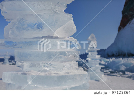Pieces of ice lying on the ideal smooth ice of baikal with ice hummocks in the horizon Pieces of ice lying on the ideal smooth ice of baikal with ice hummocks in the horizon 97125864